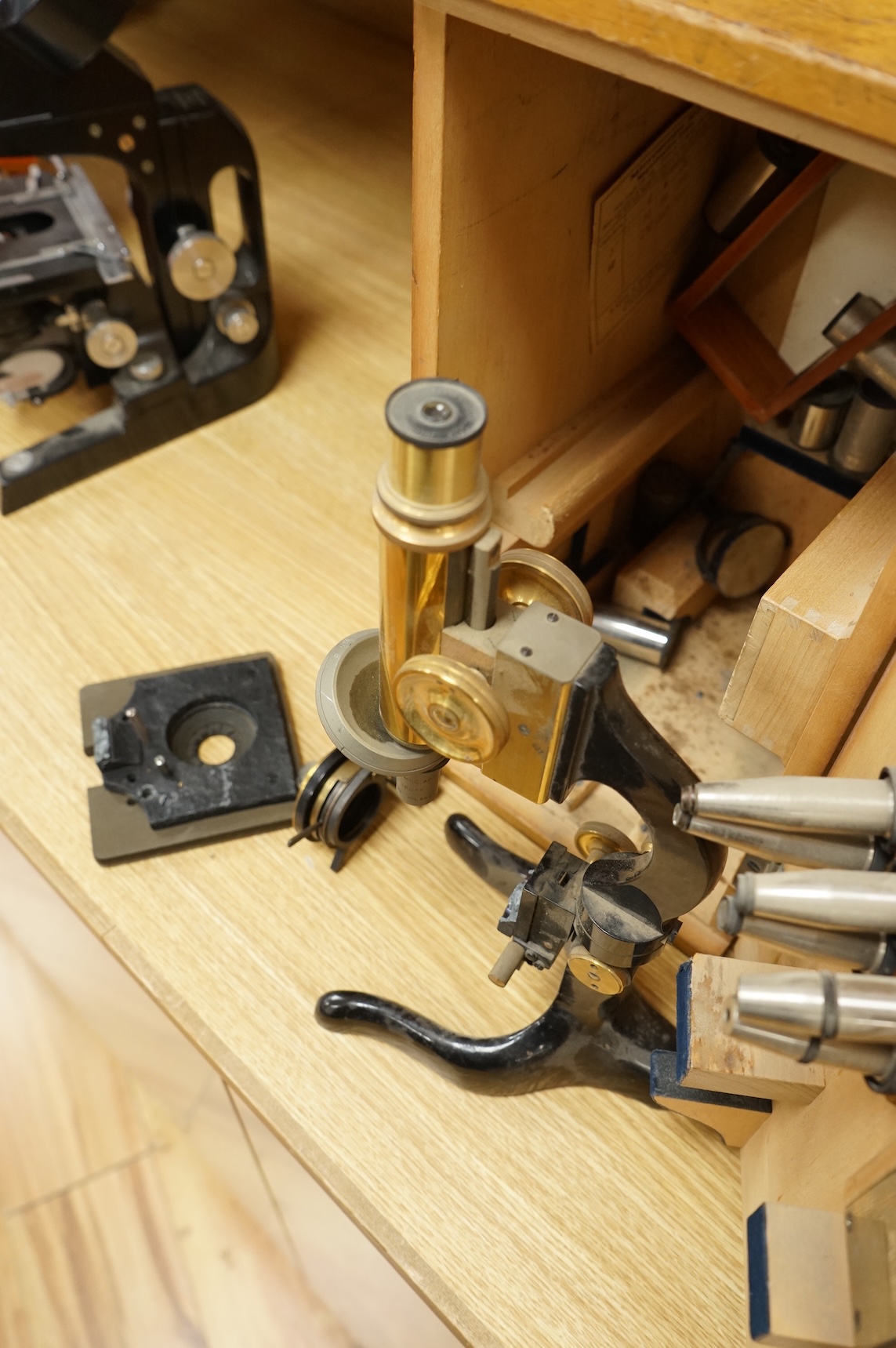 An early 20th century E. Leitz, Wetzlar, monocular microscope, in a cedar case, together with a number of alternative lenses and other accessories, case height 37.5cm.